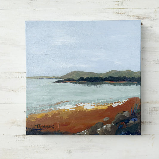 Painting of a coastal scene with an island and sandy beach on a textured white surface, titled "Shore" by Teri Stephens Art.