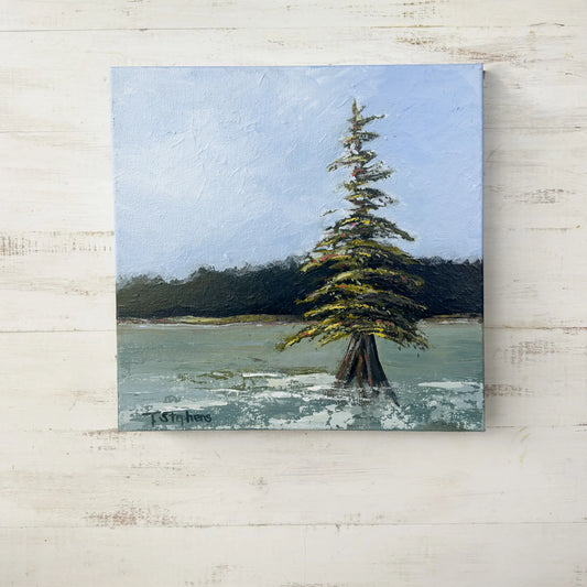 Painting of a lone tree by a body of water with a blue sky. "Stand" by Teri Stephens