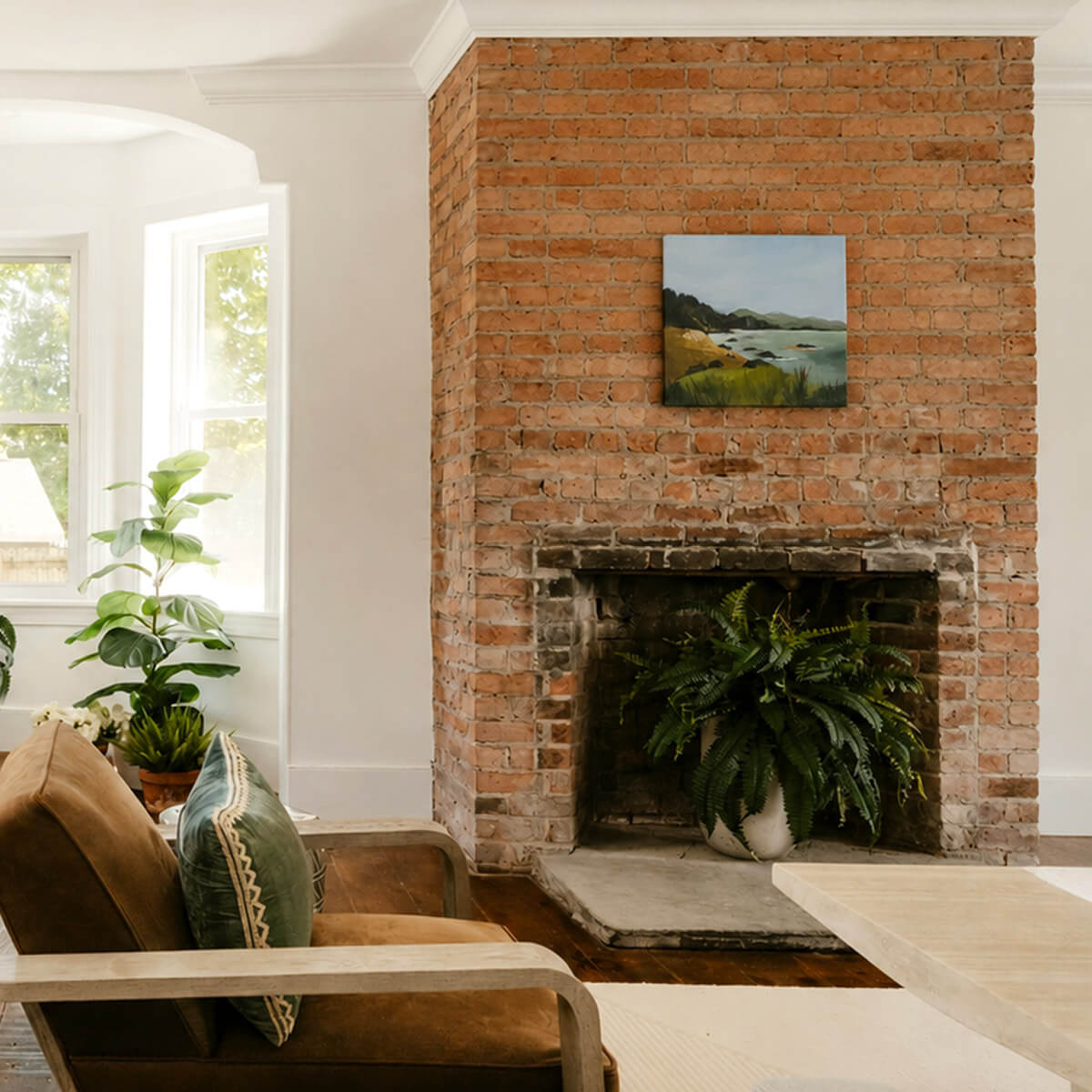 Landscape Paintings by artist Teri Stephens, styled in a warm interior over a fireplace.
