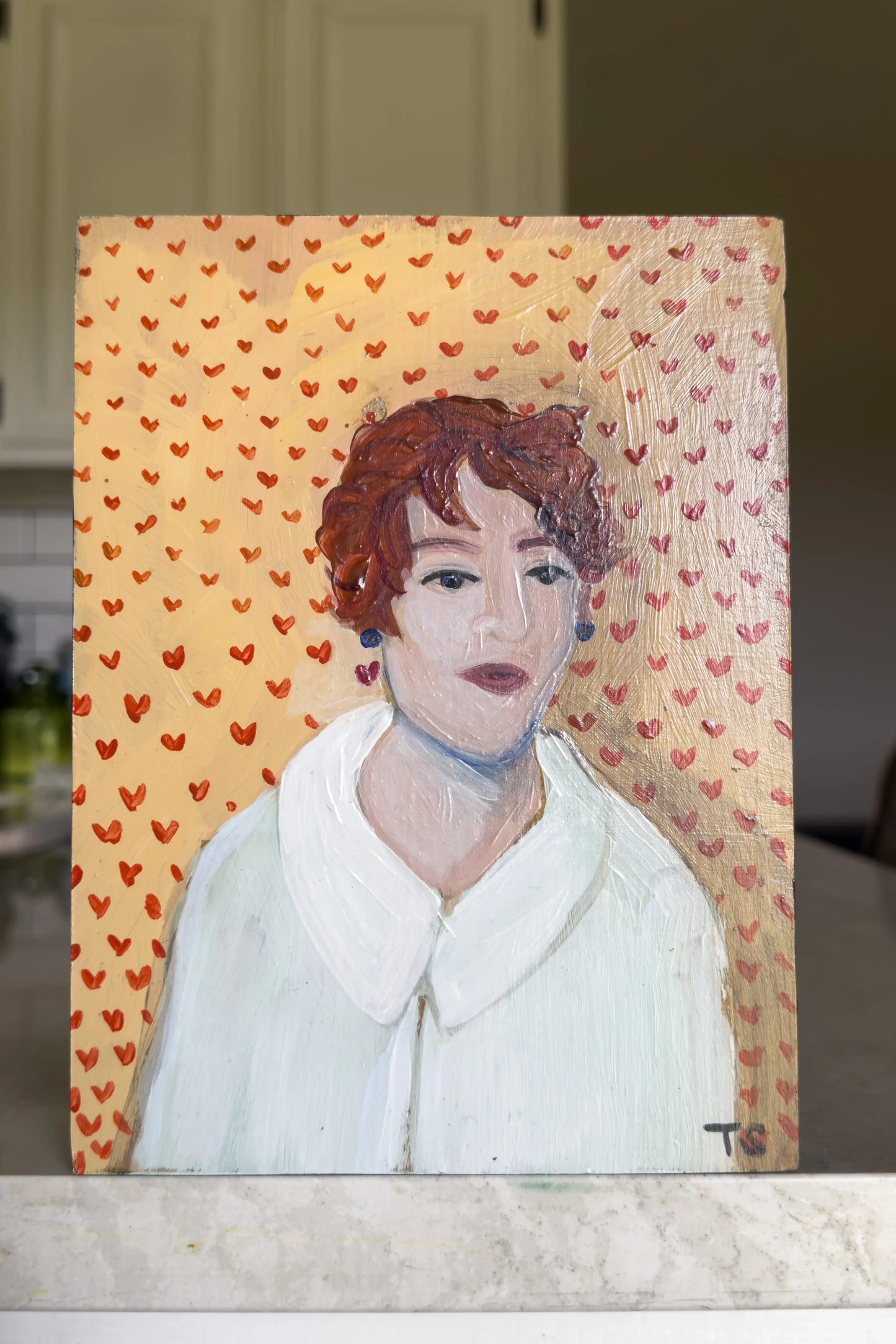 Portrait of a woman with red hair on a background with small red hearts.