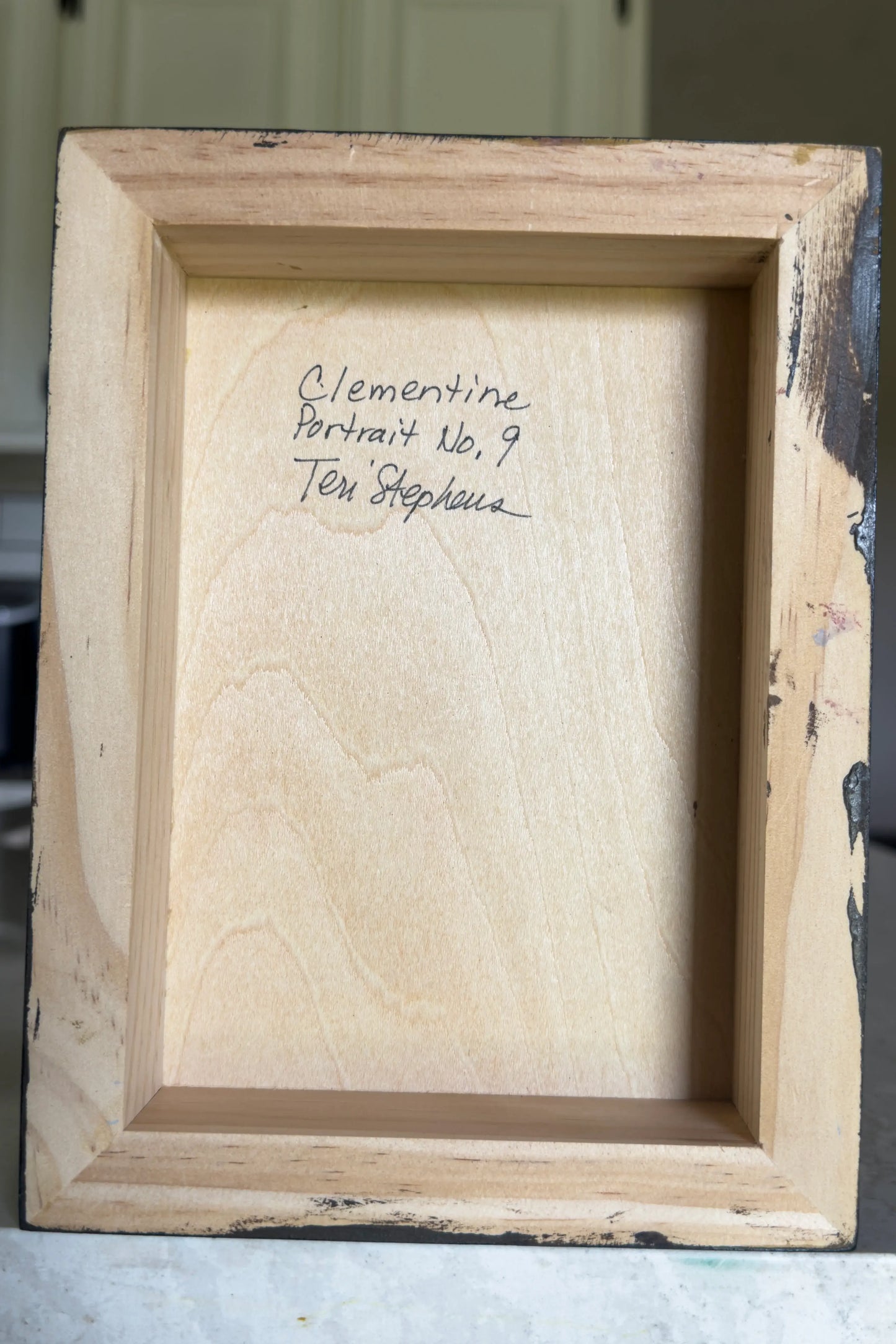 wooden picture frame with artist signature