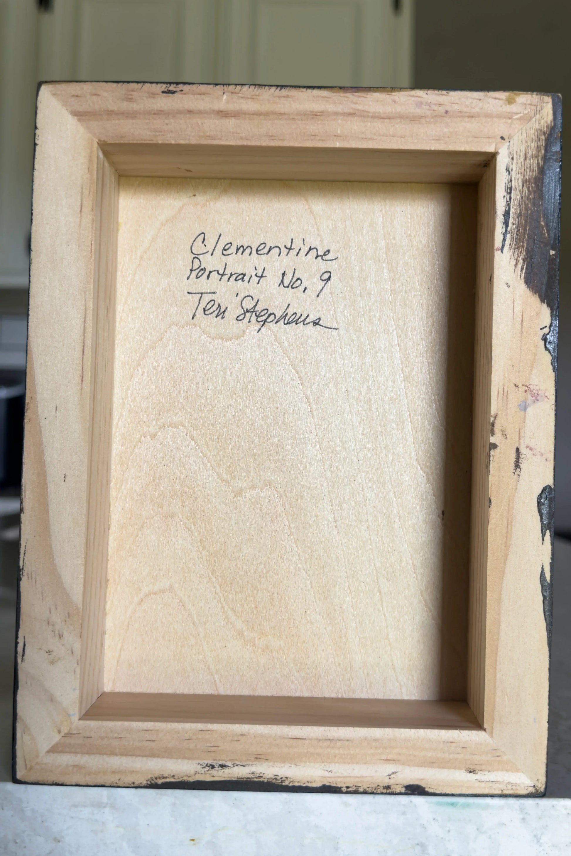 wooden picture frame with artist signature
