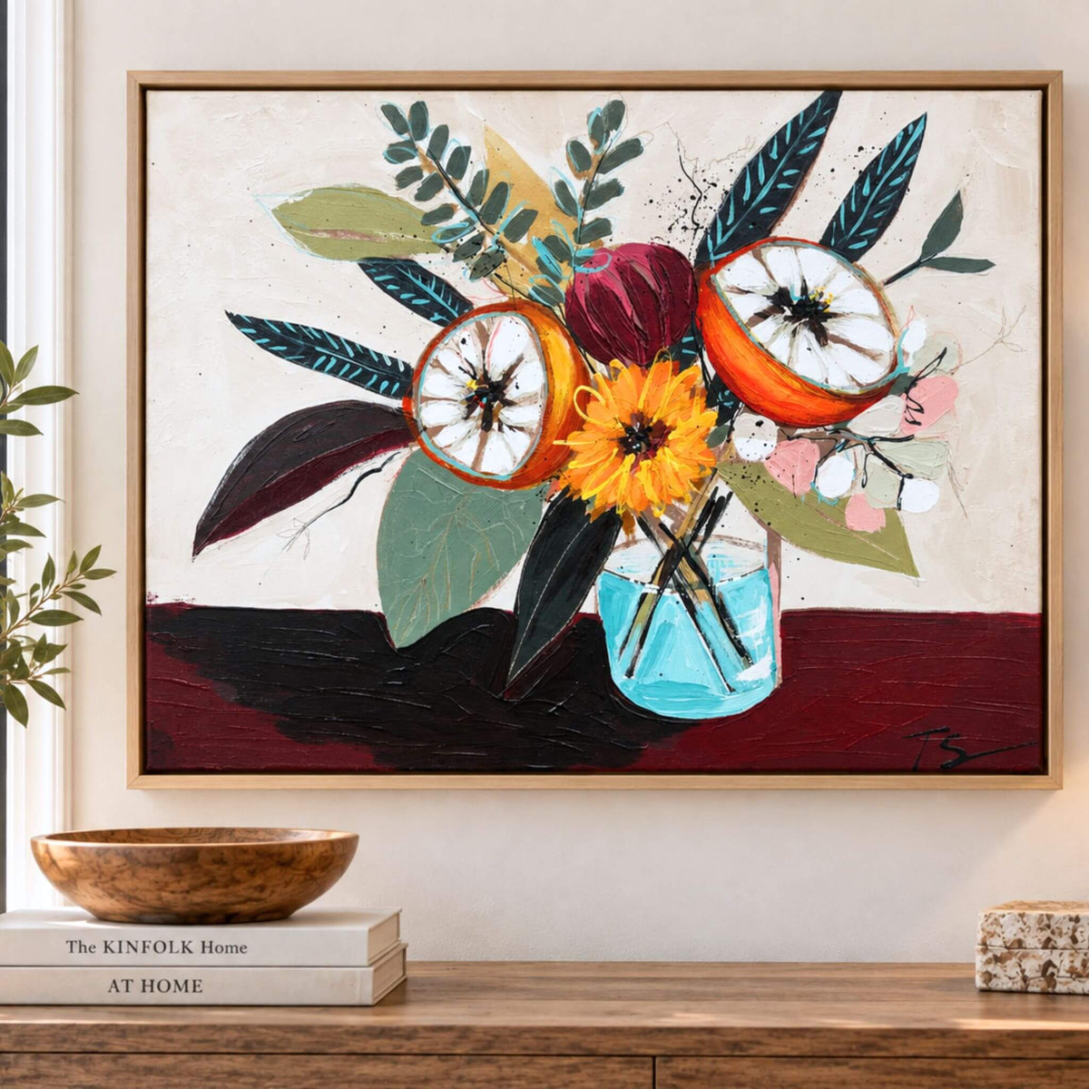 Gathered is an original floral still life painting by Teri Stephens, featuring orange fruit, yellow flowers and expressive foliage in a turquoise vase, shown in a natural wood floater frame.