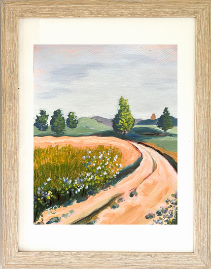 Framed painting of a rural landscape with a winding road and green hills. Original artwork titled "Curve" by artist Teri Stephens
