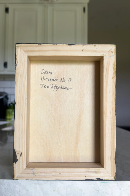 back view of a painting on wood panel with artist signature