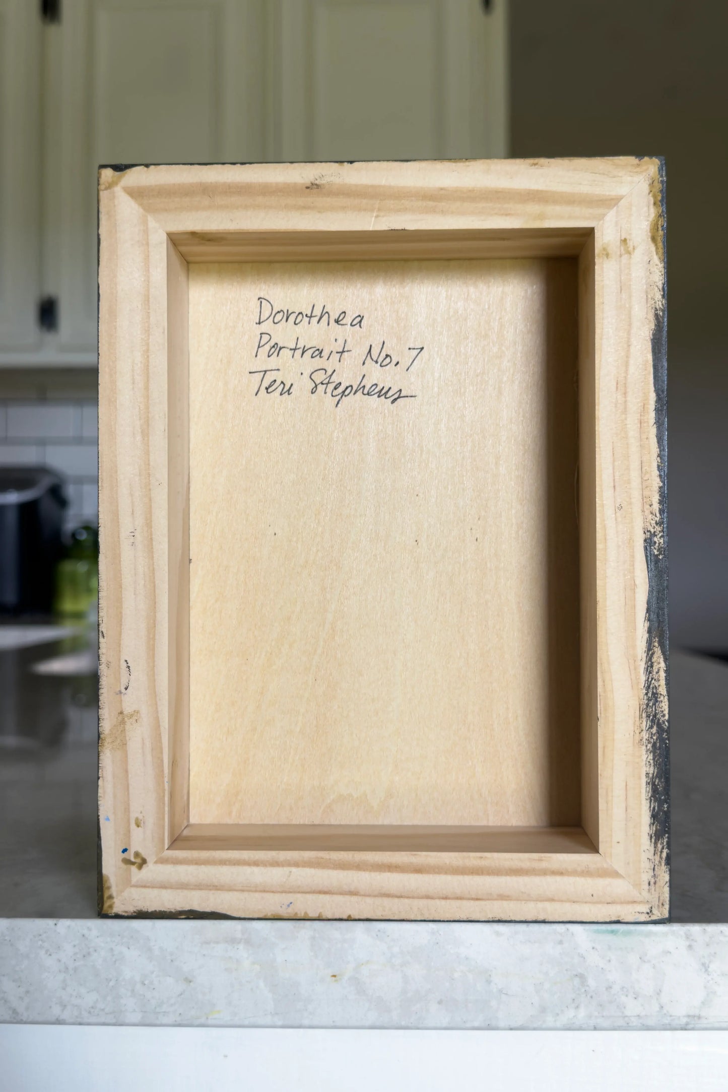 artist signature on back of a wood panel