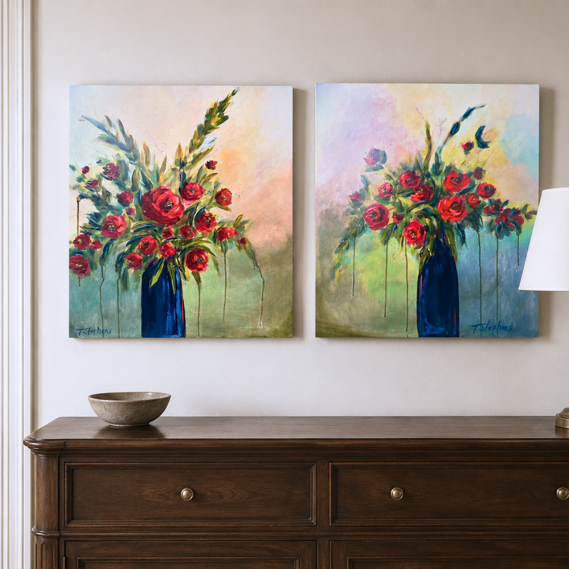 Two original paintings titled Tomorrow and Yesterday by artist Teri Stephens, 24 x 30 on gallery canvas, featuring bold red blooms on strong green stems in a rich blue vase on a muted, atmospheric background. Styled in a neutral traditional interior
