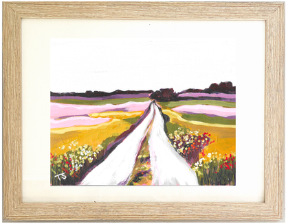 Framed artwork of a colorful landscape with a white path, "Fields" by artist Teri Stephens
