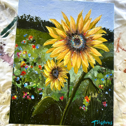 Painting of two sunflowers with a colorful background on a textured surface. Glory by artist Teri Stephens
