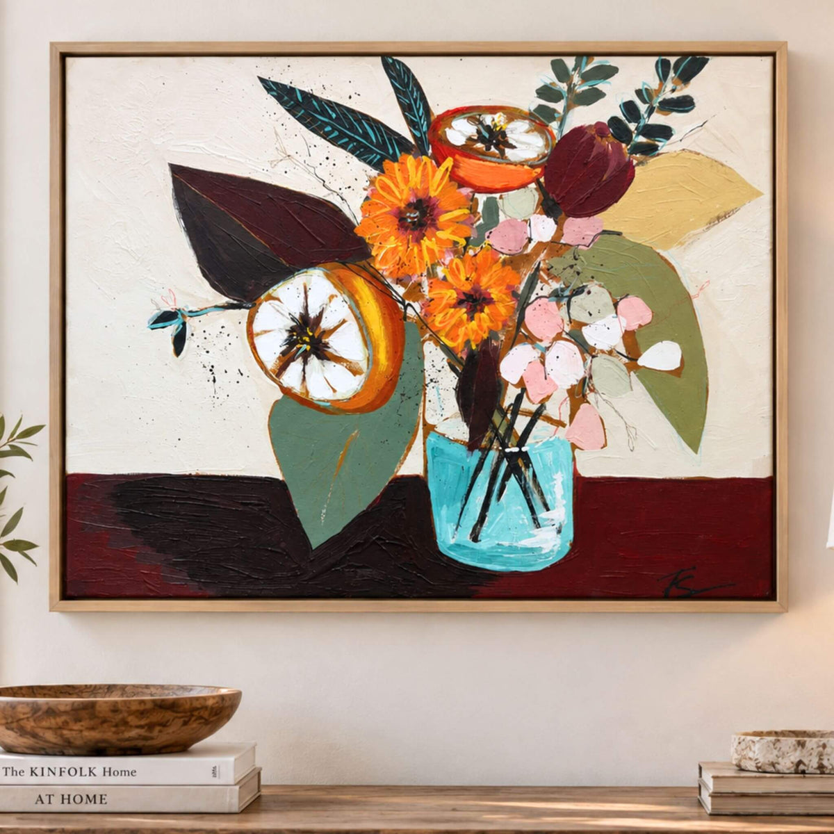 Gathered is an original floral still life painting by Teri Stephens, featuring orange fruit, yellow flowers and expressive foliage in a turquoise vase, shown in a natural wood floater frame.