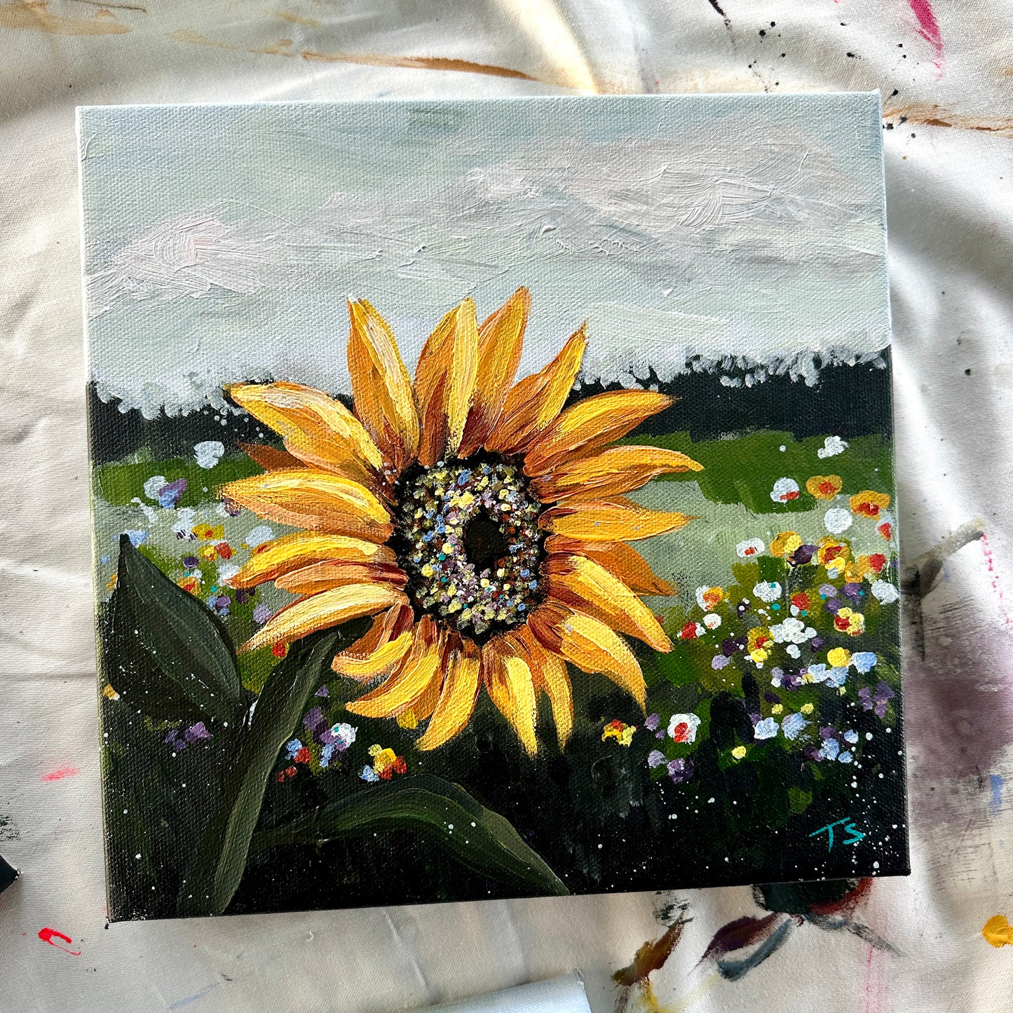 Painting of a sunflower with a colorful background on a textured surface, title Golden by artist Teri Stephens
