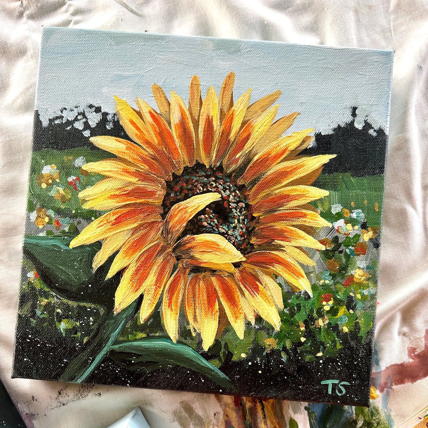 Painting of a sunflower with a garden background on a textured surface, title Halo by artist Teri Stephens