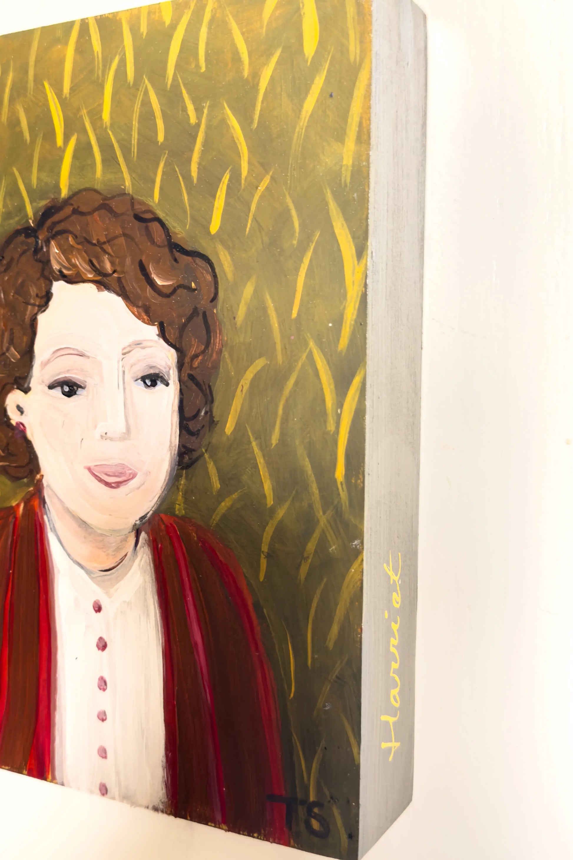 side view of painting titled "Harriet" by artist Teri Stephens, featuring a portrait of a woman wearing a red sweater on a texture green / gold background