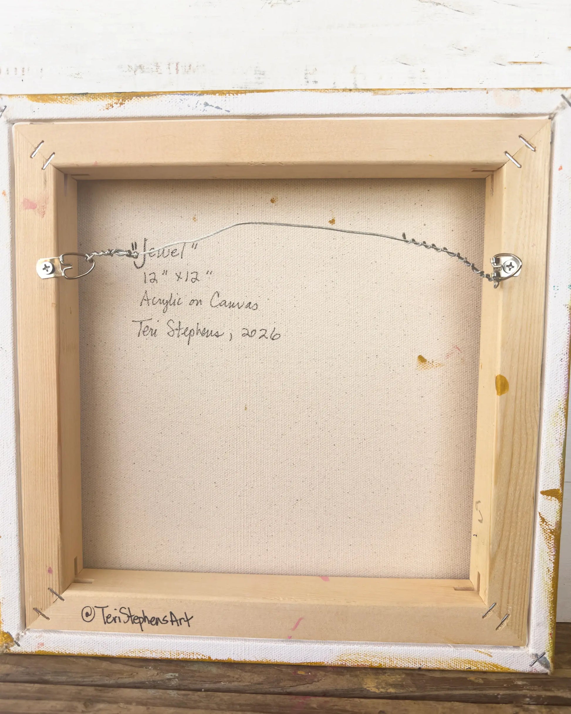 Back of a framed painting with artist's signature and details, "Jewel" by Teri Stephens