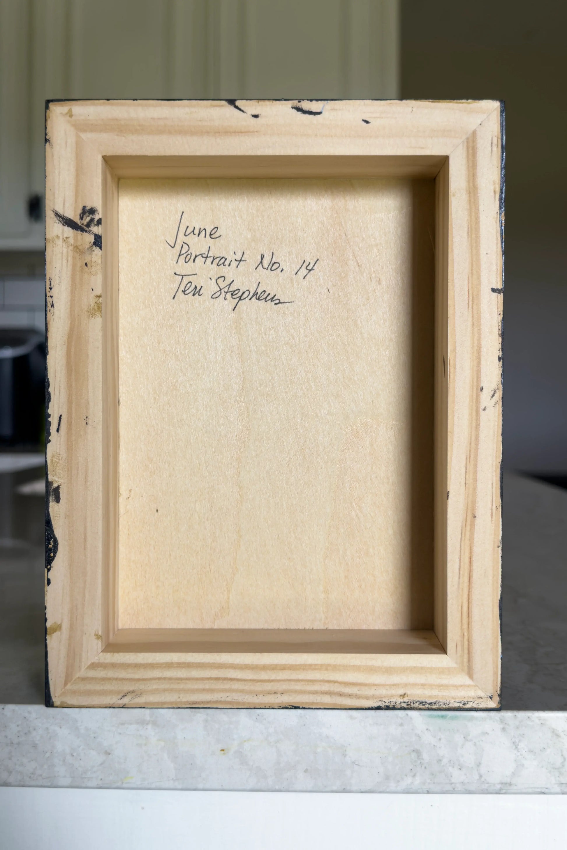 Wooden picture frame with text on a neutral background