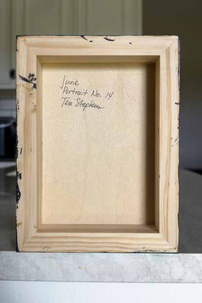Wooden picture frame with text on a neutral background