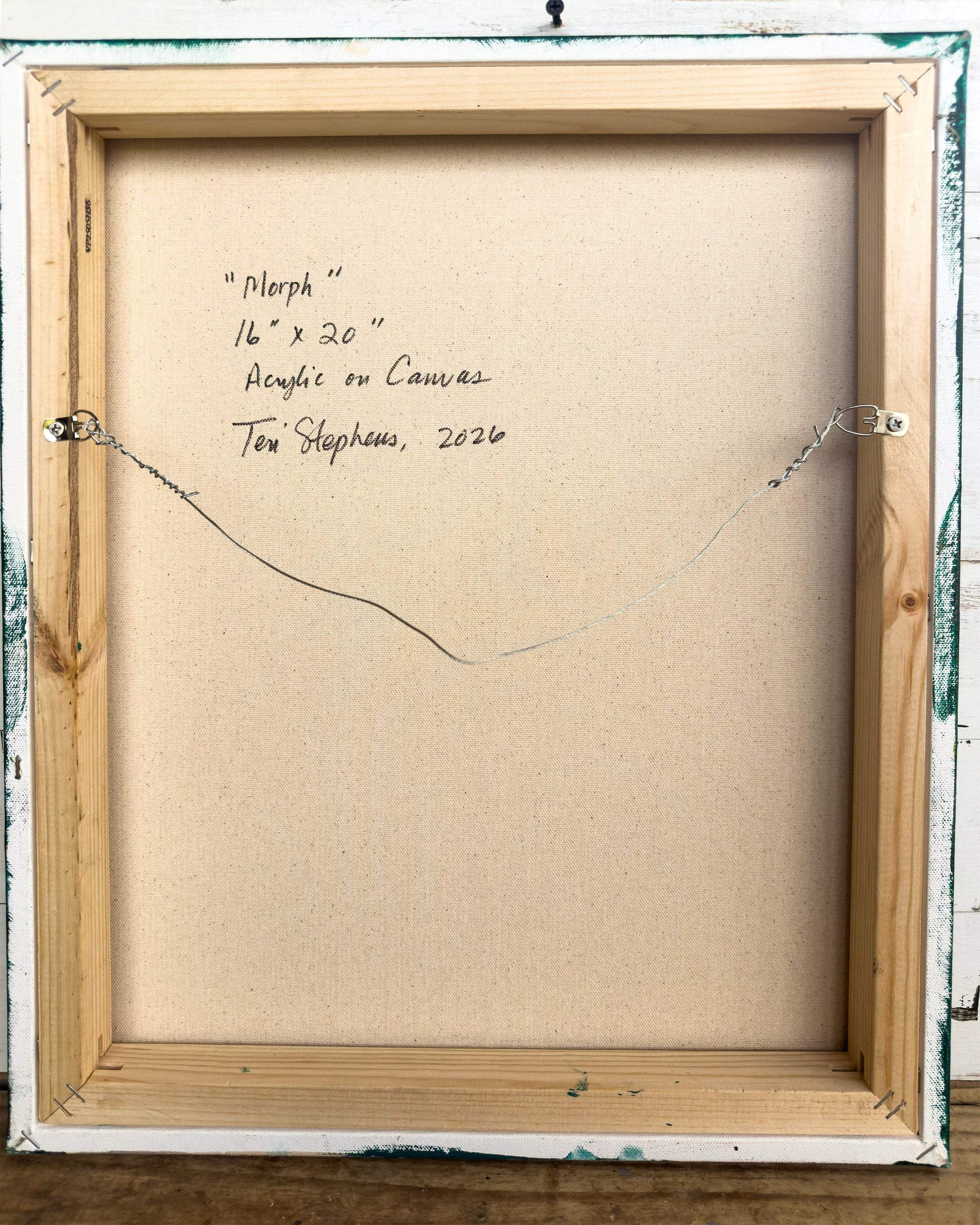 Back of a framed painting with artist's signature and details