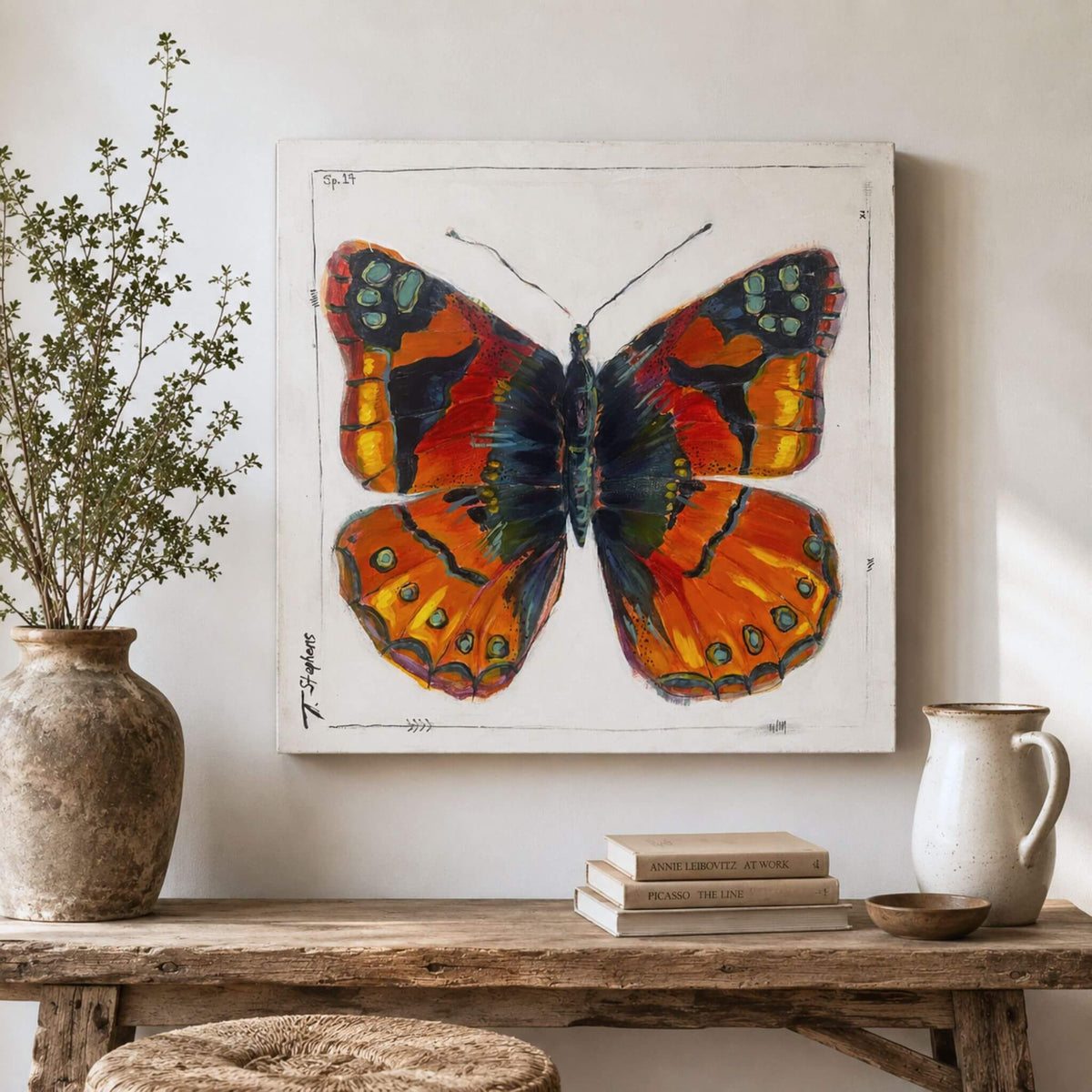 Painted is an original butterfly painting in a boldly colored butterfly with wings of red, yellow, orange, and deep blue. By artist Teri Stephens