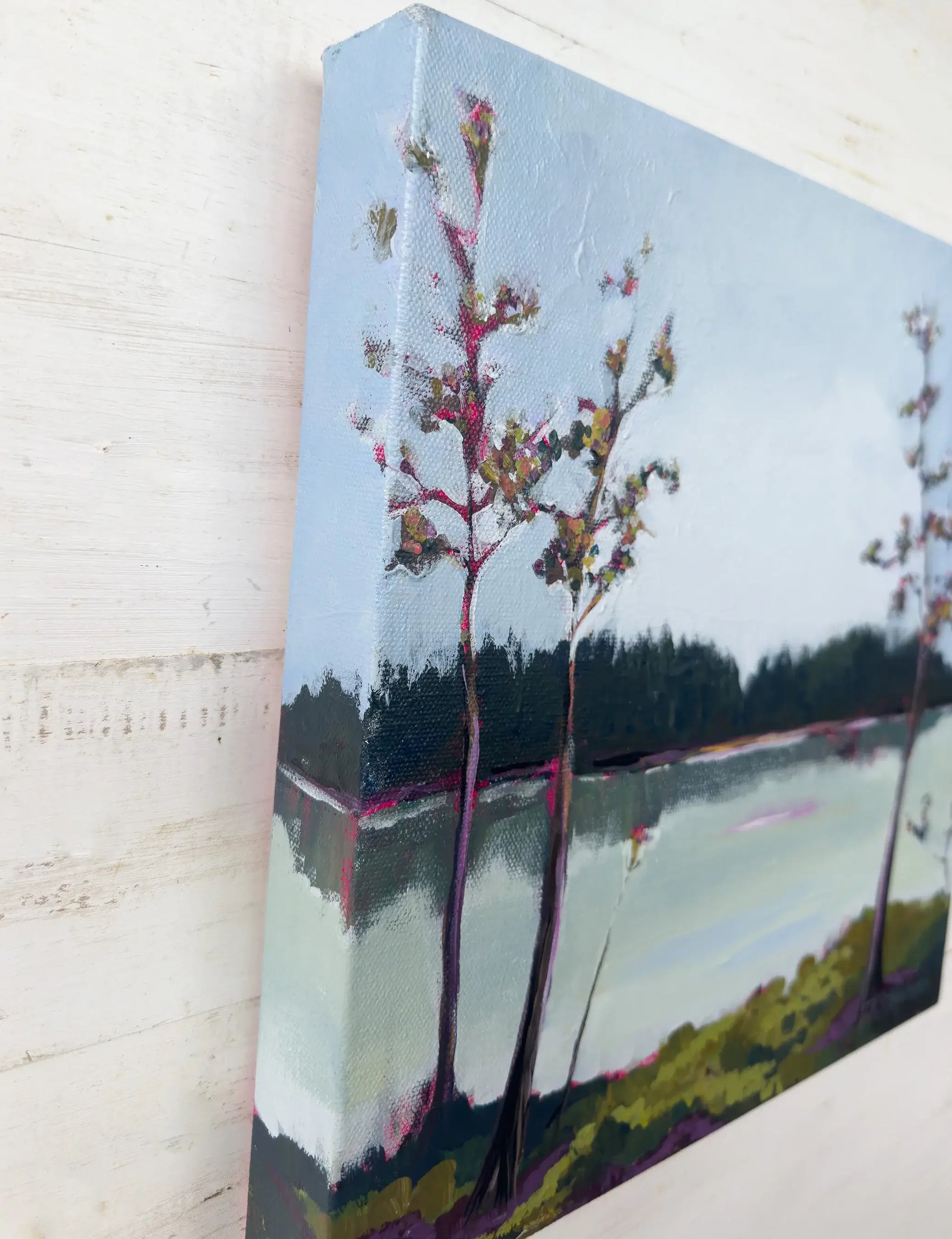 Painting on canvas of a landscape with trees and water, angled view of original painting titled "Pond" by Teri Stephens