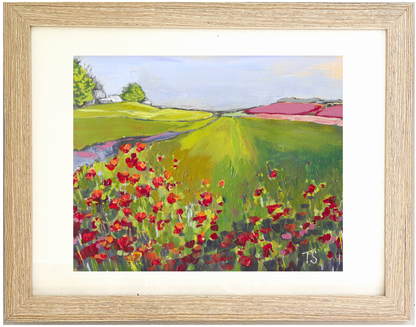 Framed painting of a landscape with red flowers, green fields, and a blue sky. Poppy by Teri Stephens