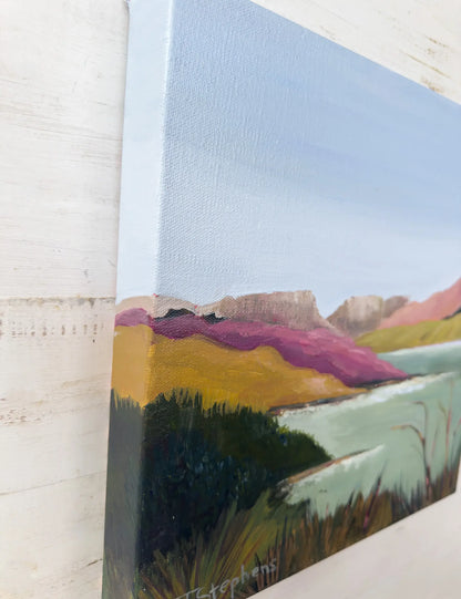 Close-up of a landscape painting with a textured wall background, angled view of  original painting titled "Reservoir" by Teri Stephens