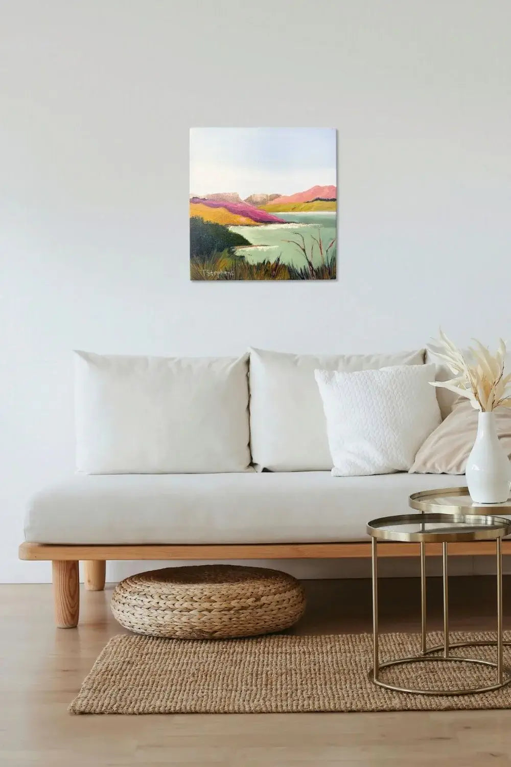Living room with a white sofa, wooden coffee table, and a colorful abstract painting on the wall. Original artwork is a painting titled "Reservoir" by Teri Stephens Art.