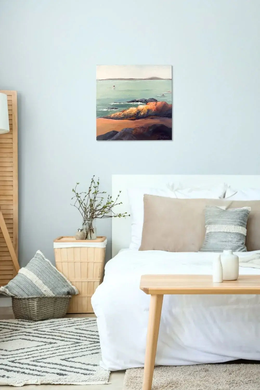 Cozy bedroom with a bed, table, and wall art titled "Rock" by Teri Stephens Art.