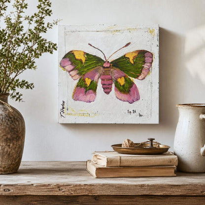 Rosy is an original butterfly painting featuring a Rosy Maple Moth in muted tones of pink, green and gold on a textured white background.