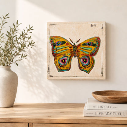 Scatter is a colorful, golden painting of a moth on canvas, created by Tennessee artist Teri Stephens