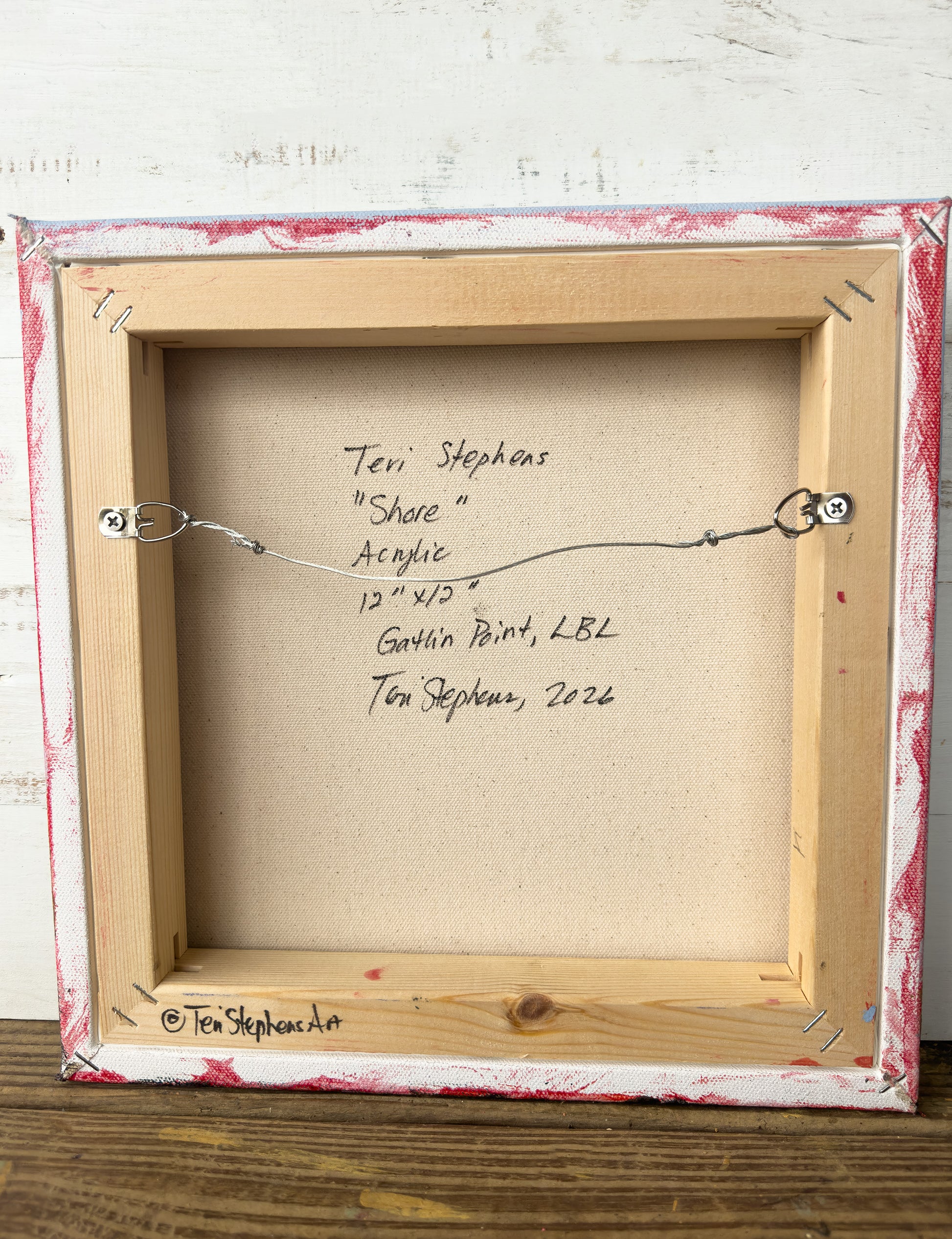 Framed artwork with signature on a wooden surface, "Shore" by Teri Stephens, 2026