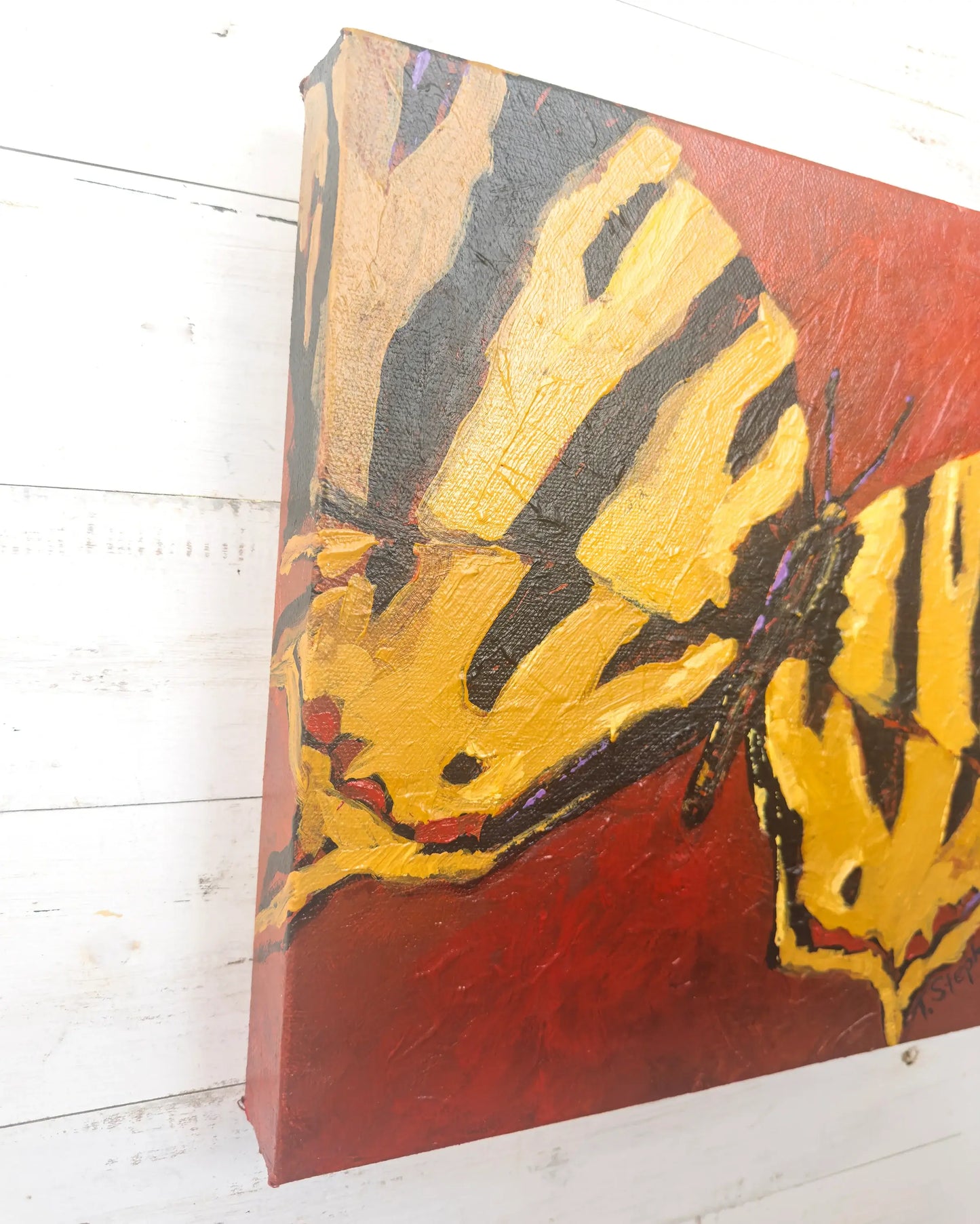 Painting of a butterfly with yellow wings on a red background, angled view of original artwork titled "Signal" by Teri Stephens