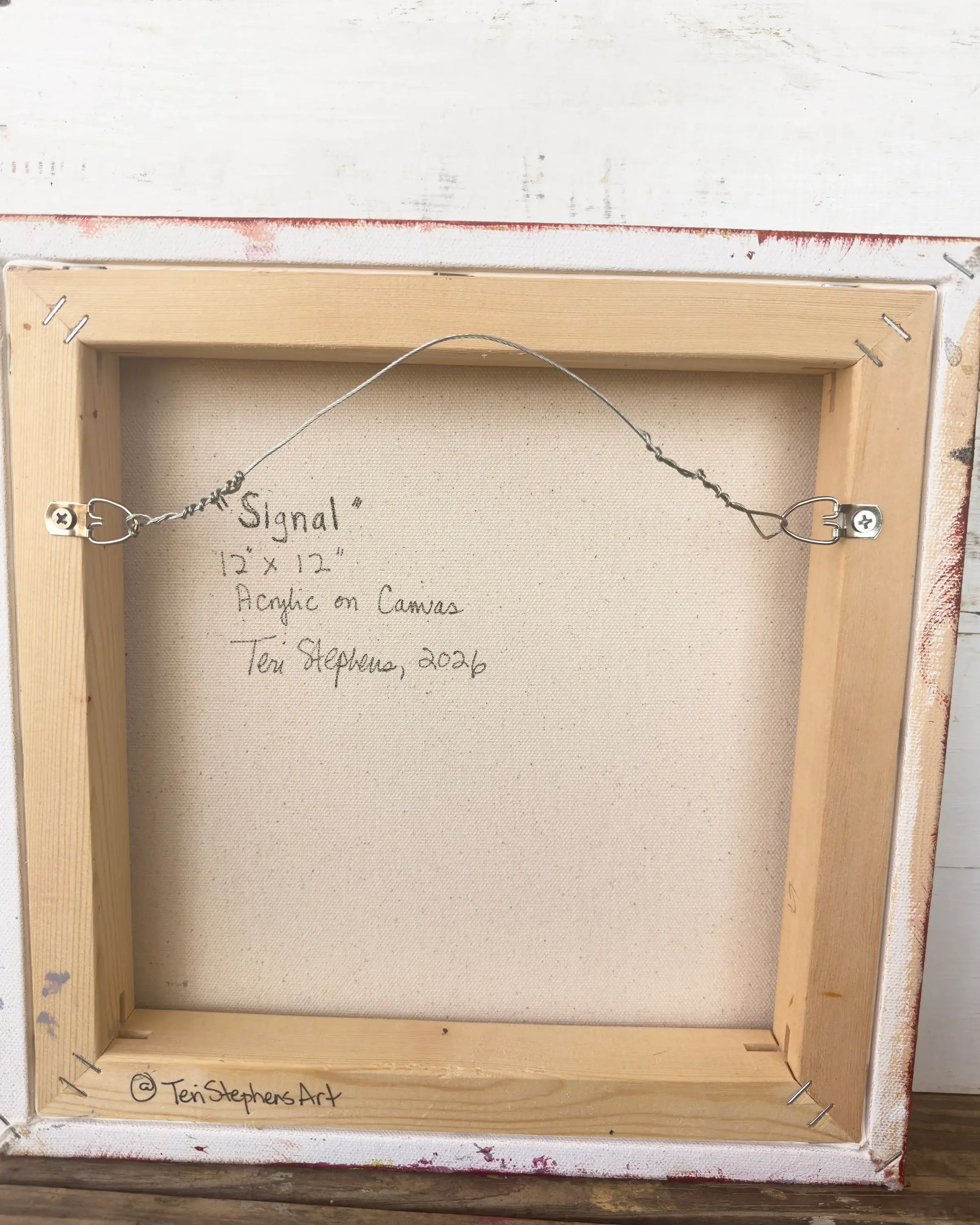 Framed artwork with signature and details on a textured white wall, "Signal" by Teri Stephens
