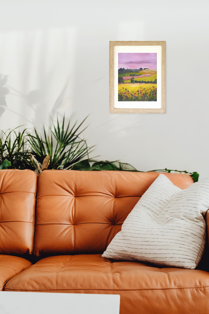 Framed artwork, original painting titled Slope by artist Teri Stephens, above a brown leather sofa with decorative pillows