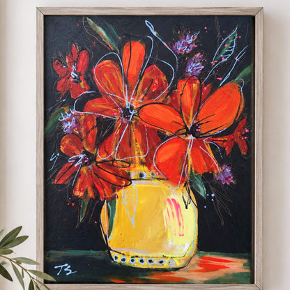 A framed painting of vibrant orange flowers in a yellow vase against a dark background, displayed on a light beige wall with a small plant leaf visible in the lower left corner. Titled "Somehow" by artist Teri Stephens