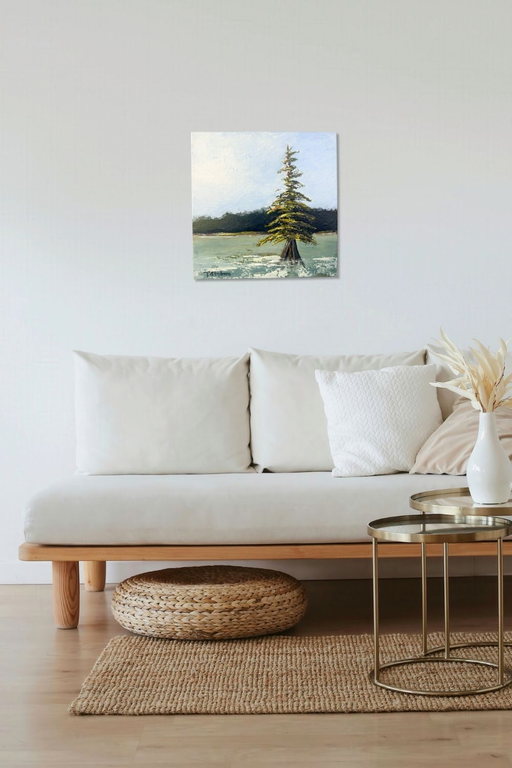 Living room with a white sofa, wooden coffee table, and a painting of a tree on the wall. Original acrylic painting titled "Stand" by Teri Stephens.